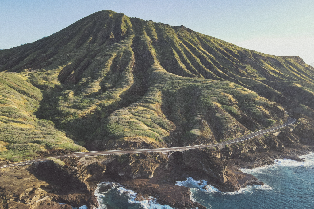 A scenic coastal highway in Oahu, winding along the shoreline with ocean views.