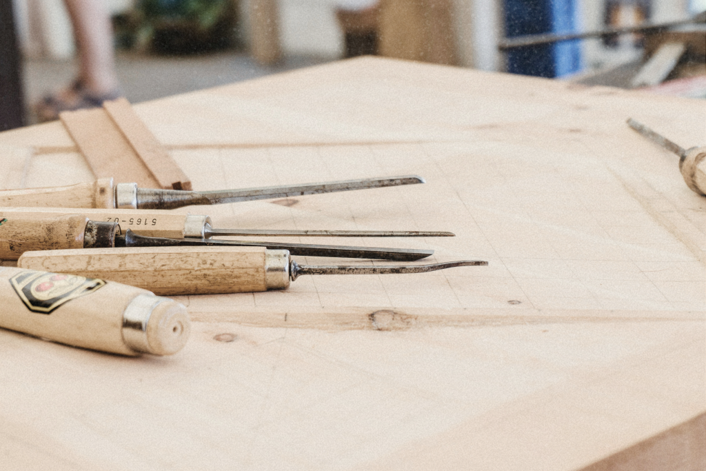Traditional wood carving tools laid out for a Polynesian wood carving activity in Oahu
